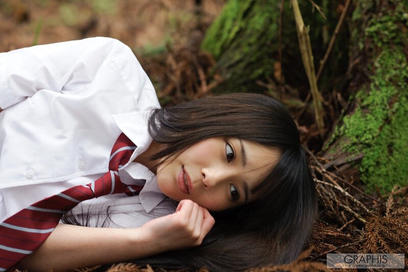 girl in school uniform lying on ground
