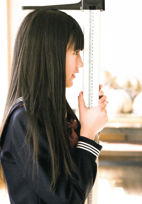 girl in school uniform measuring height