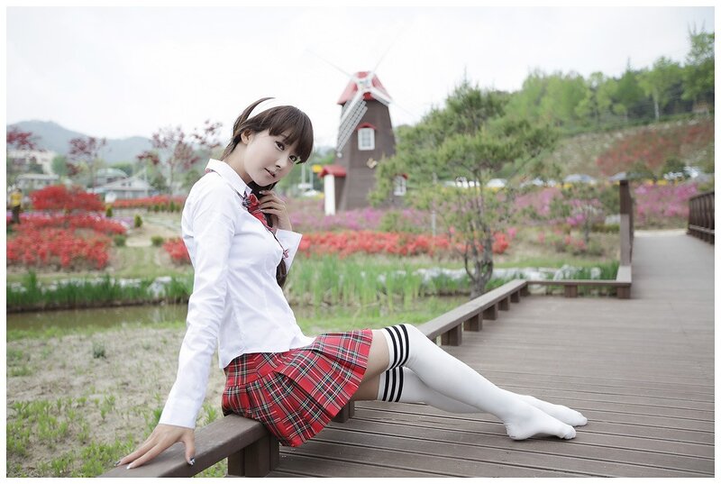 Girl in school uniform on a bridge