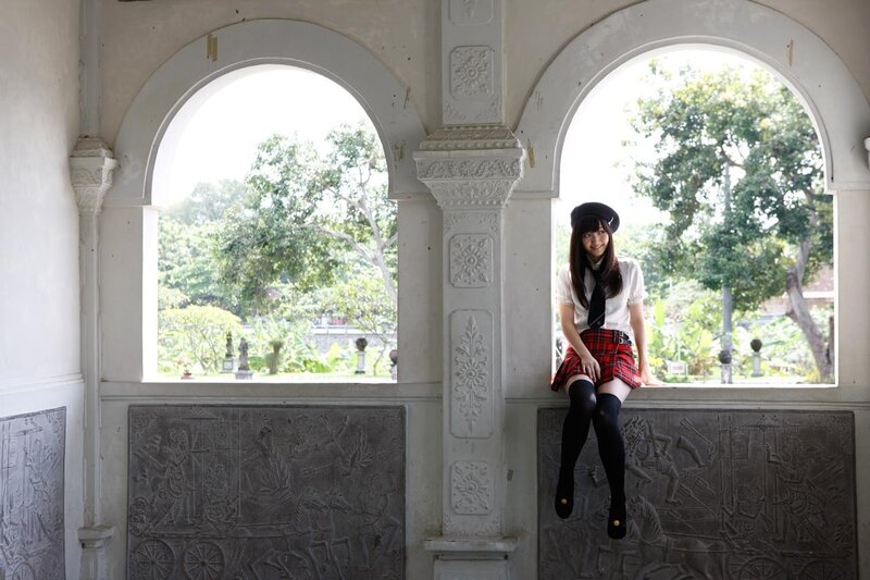 Girl in school uniform on balcony