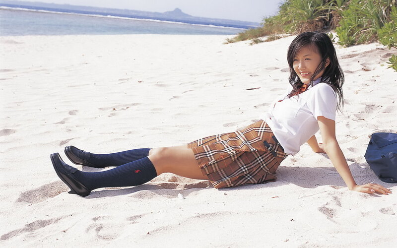girl in school uniform on beach