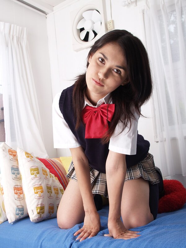 girl in school uniform on bed