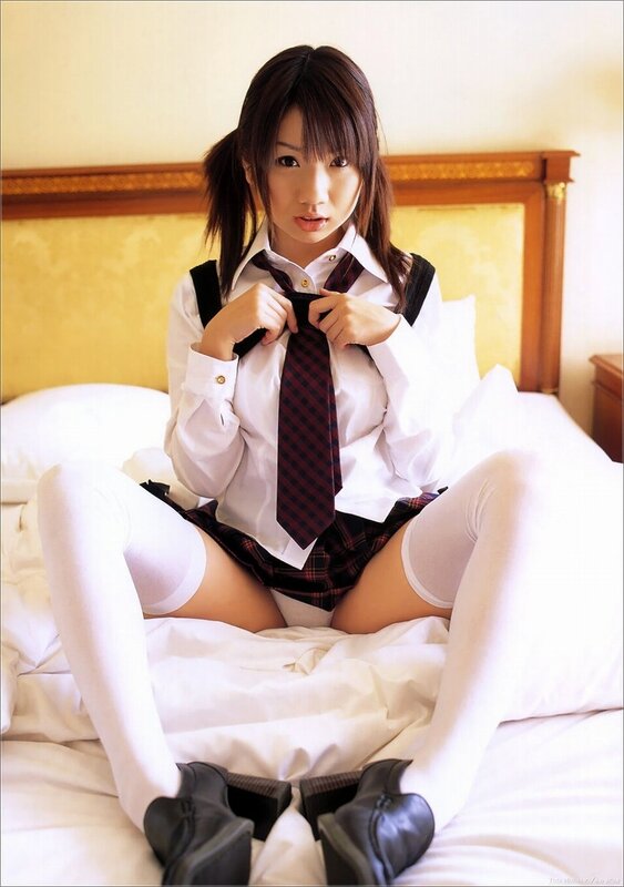 girl in school uniform on bed
