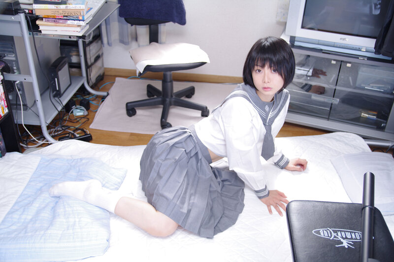 girl in school uniform on bed
