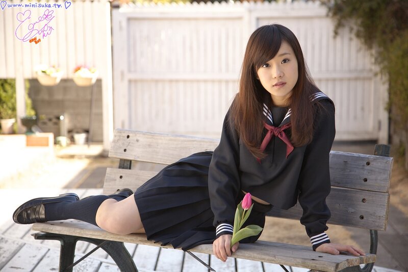Girl in school uniform on bench