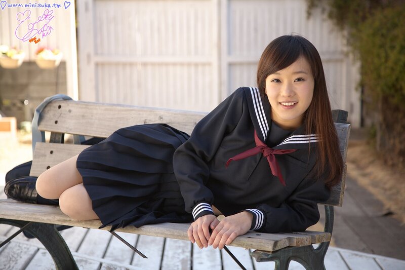 Girl in school uniform on bench