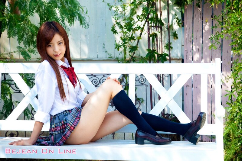 Girl in school uniform on bench
