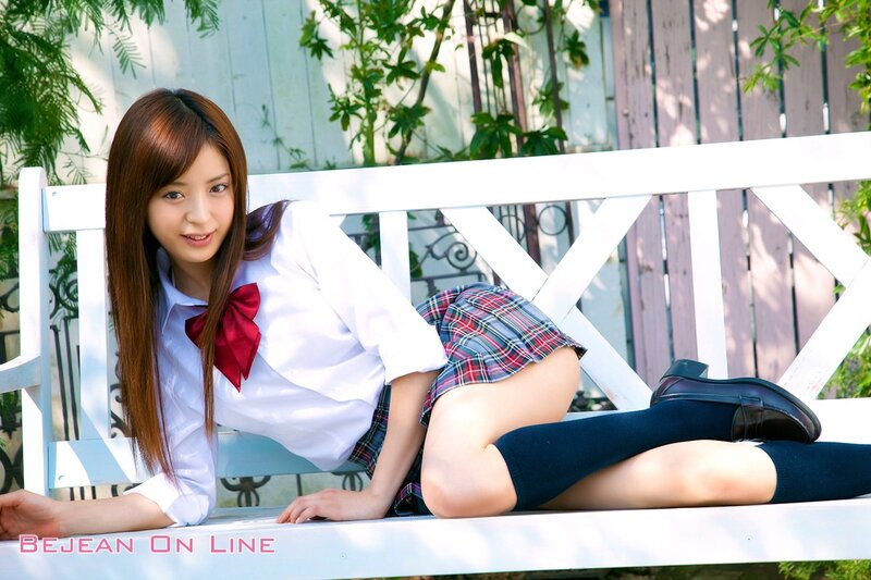 Girl in school uniform on bench