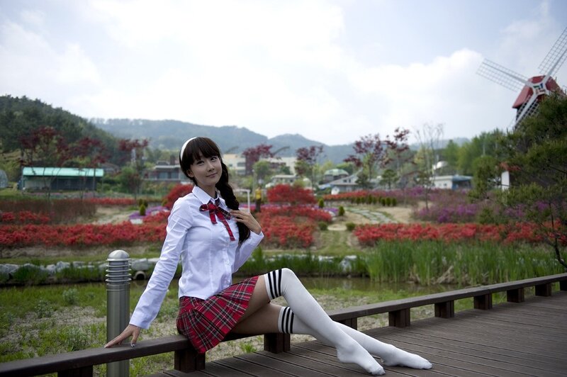 Girl in school uniform on bridge
