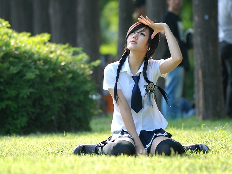 Girl in school uniform on grass
