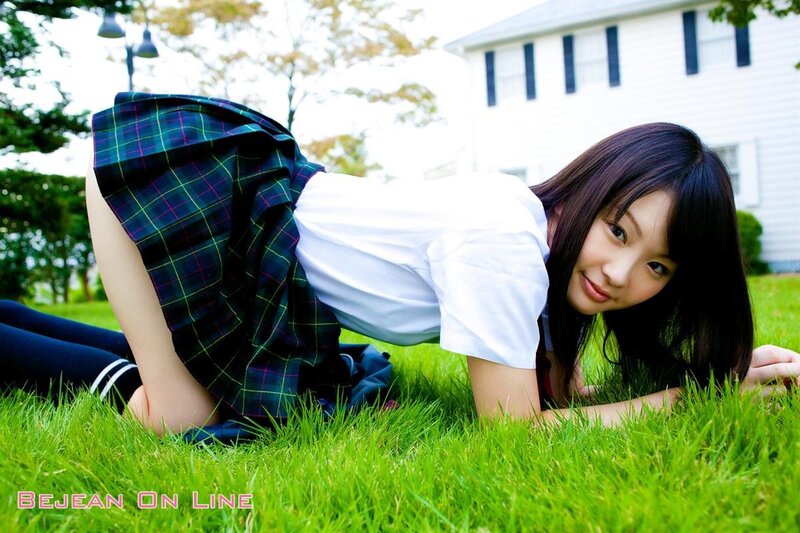 Girl in school uniform on grass