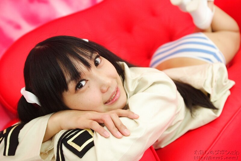 girl in school uniform on red couch