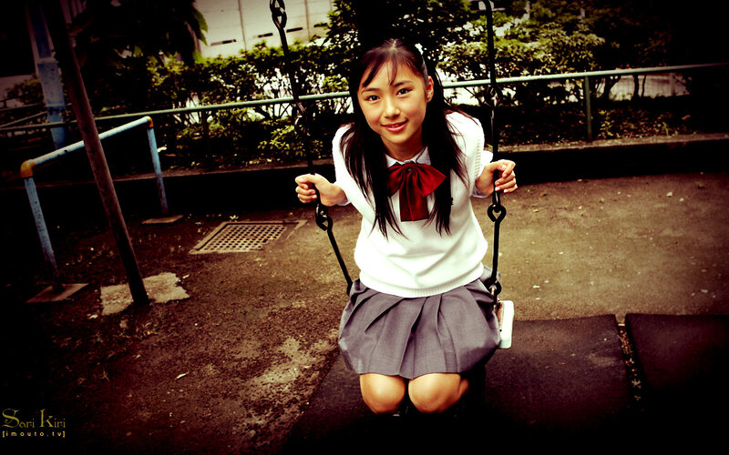 Girl in school uniform on swing