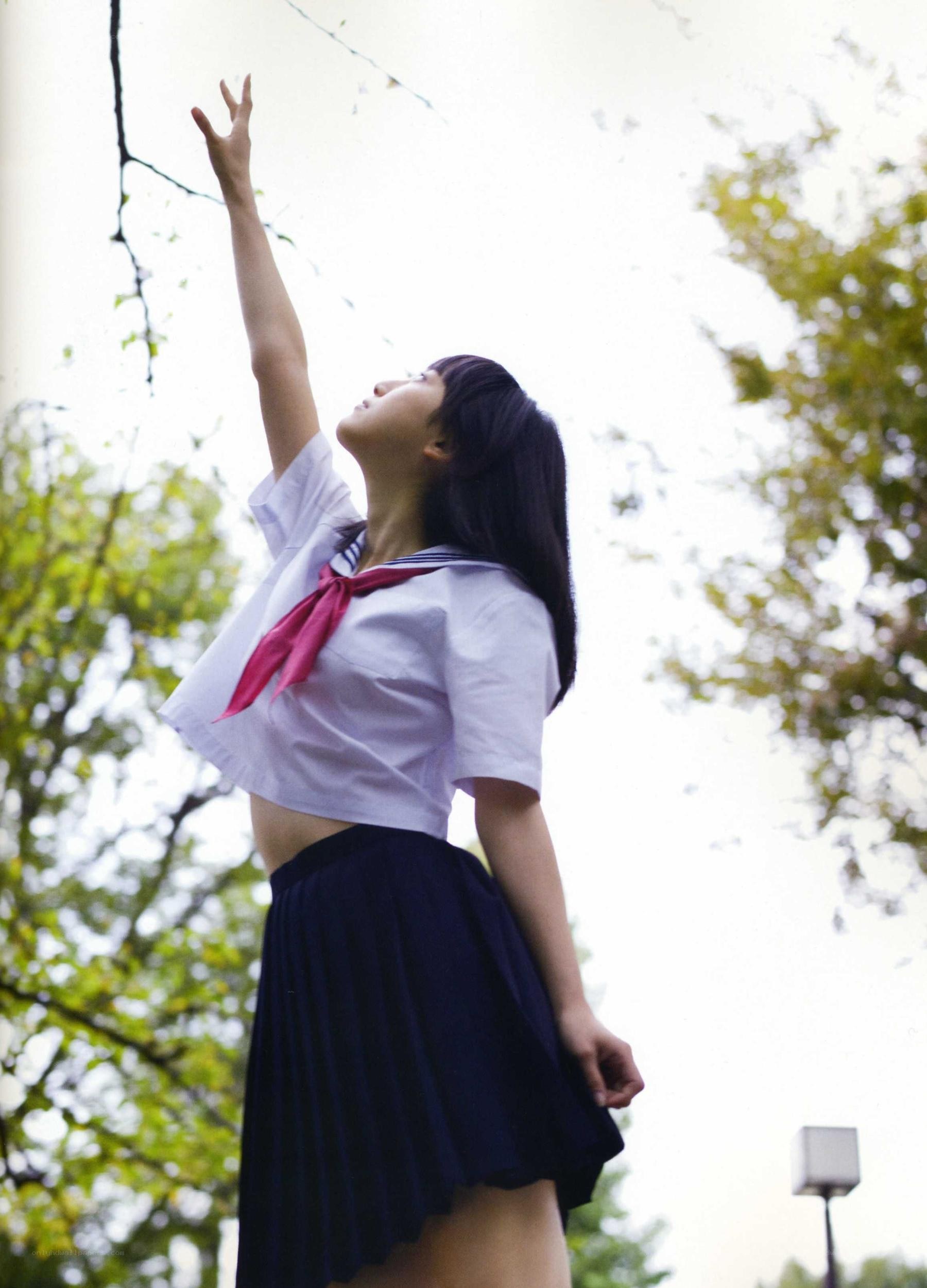 girl in school uniform reaching up