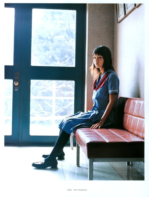 Girl in school uniform sitting