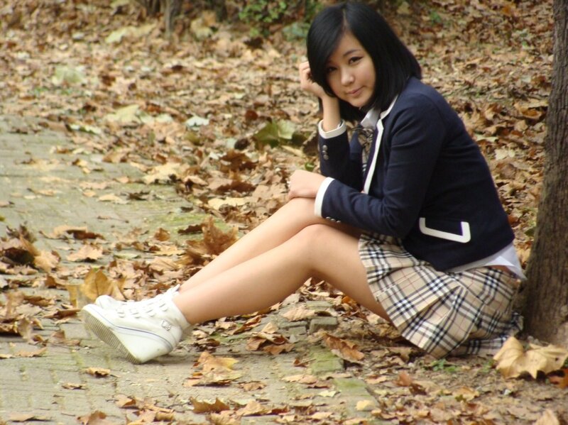 girl in school uniform sitting outside