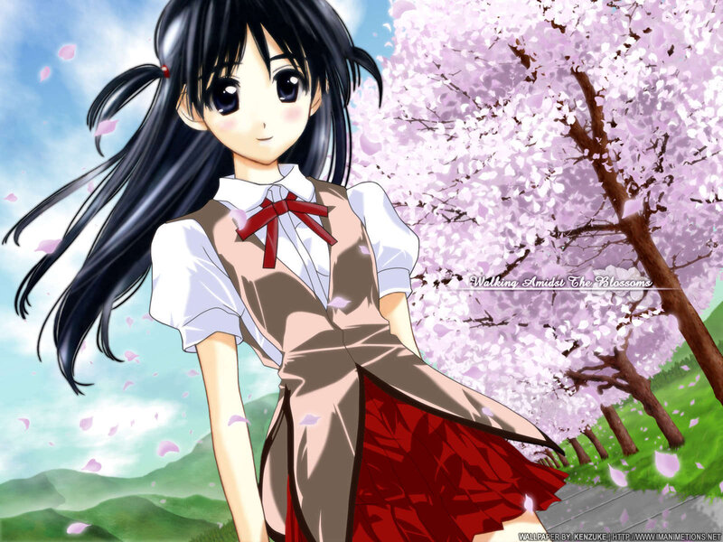 Girl in school uniform under cherry blossoms