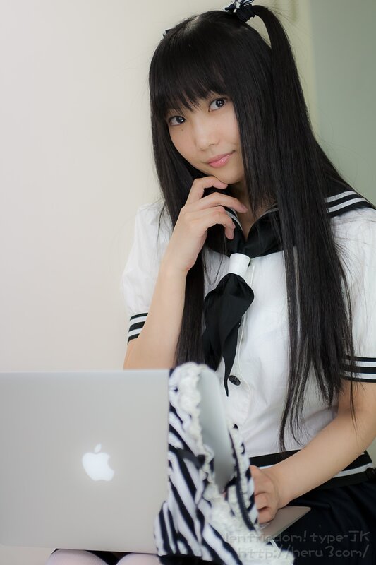 girl in school uniform with laptop