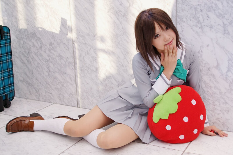 girl in school uniform with strawberry pillow