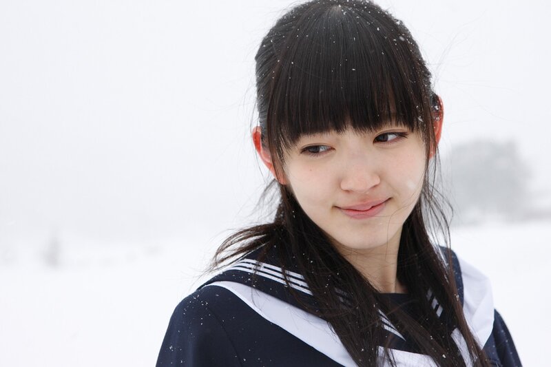 girl in snow wearing school uniform
