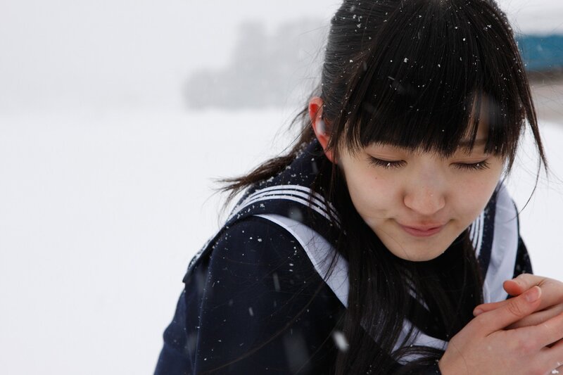 girl in snow with eyes closed
