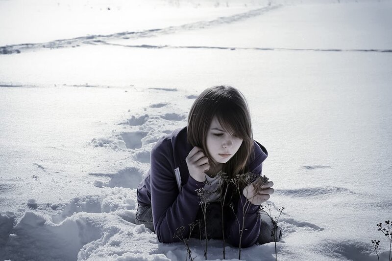 girl in snow with plant