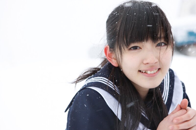 girl in snow with school uniform