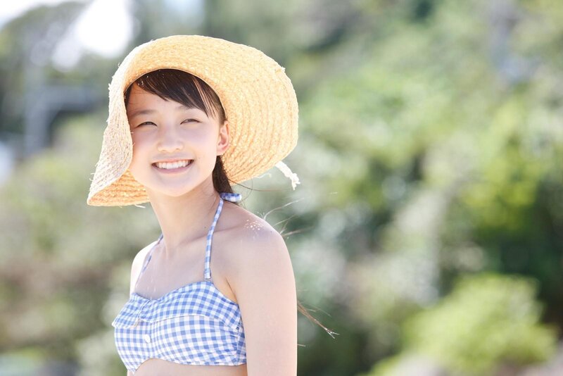 girl in straw hat smiling