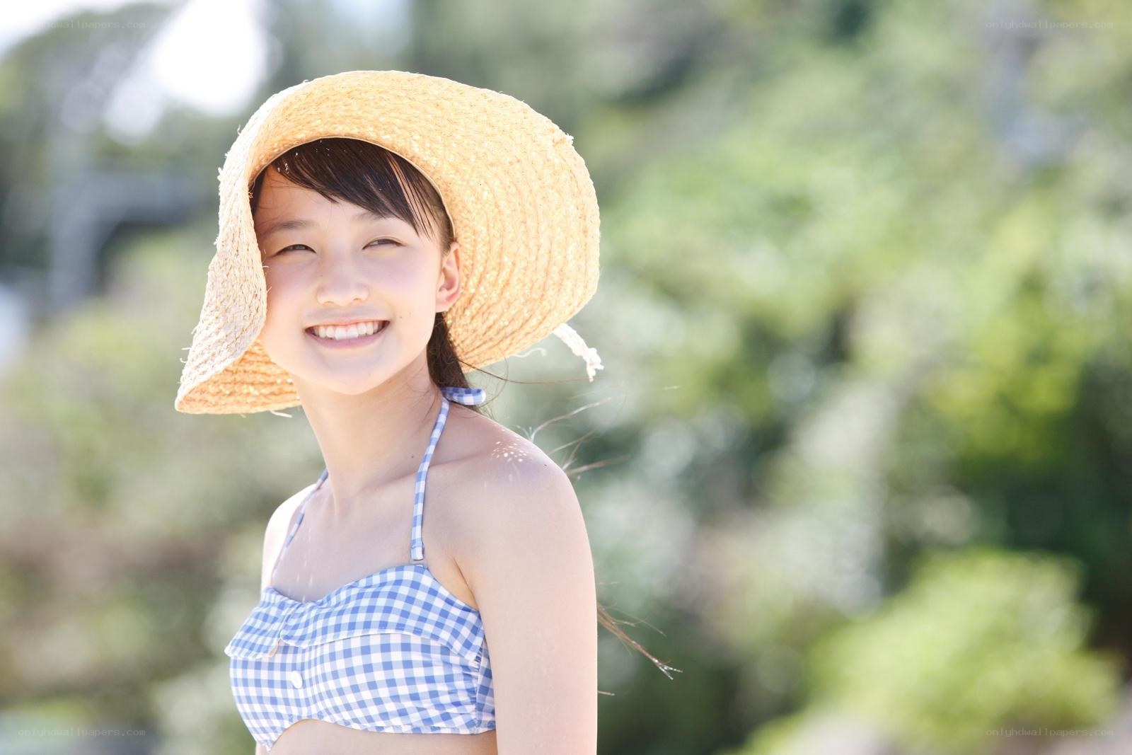 girl in straw hat smiling