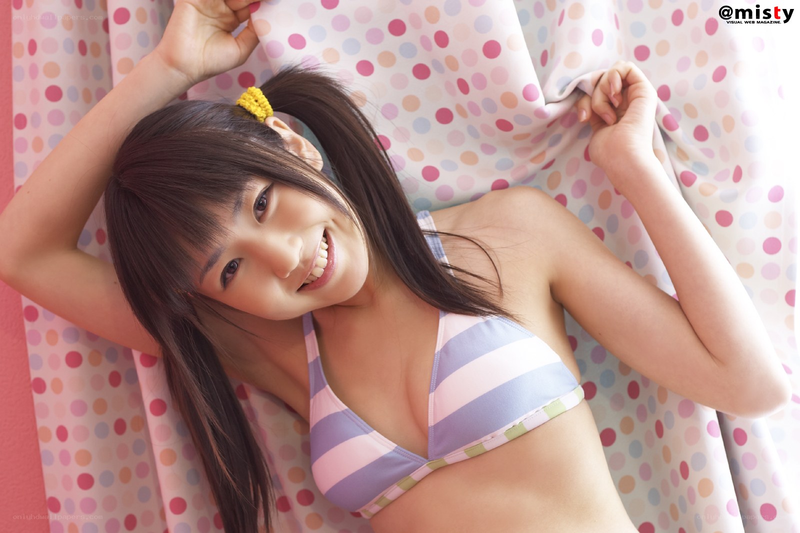 girl in striped bikini smiling