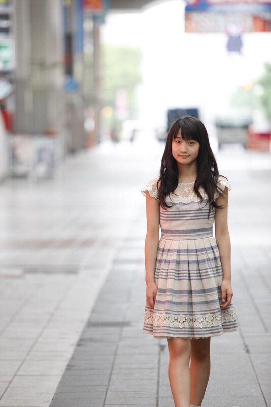 girl in striped dress on street