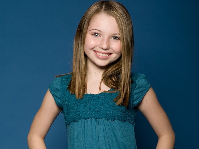 girl in teal dress smiling