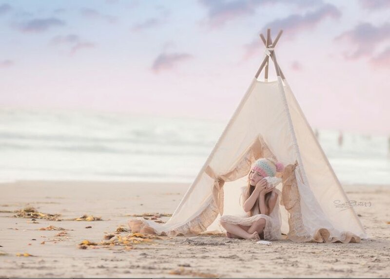 Girl in Teepee on Beach