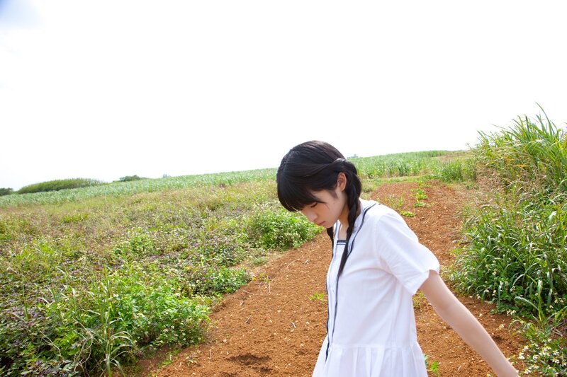 Girl in white dress on a dirt path