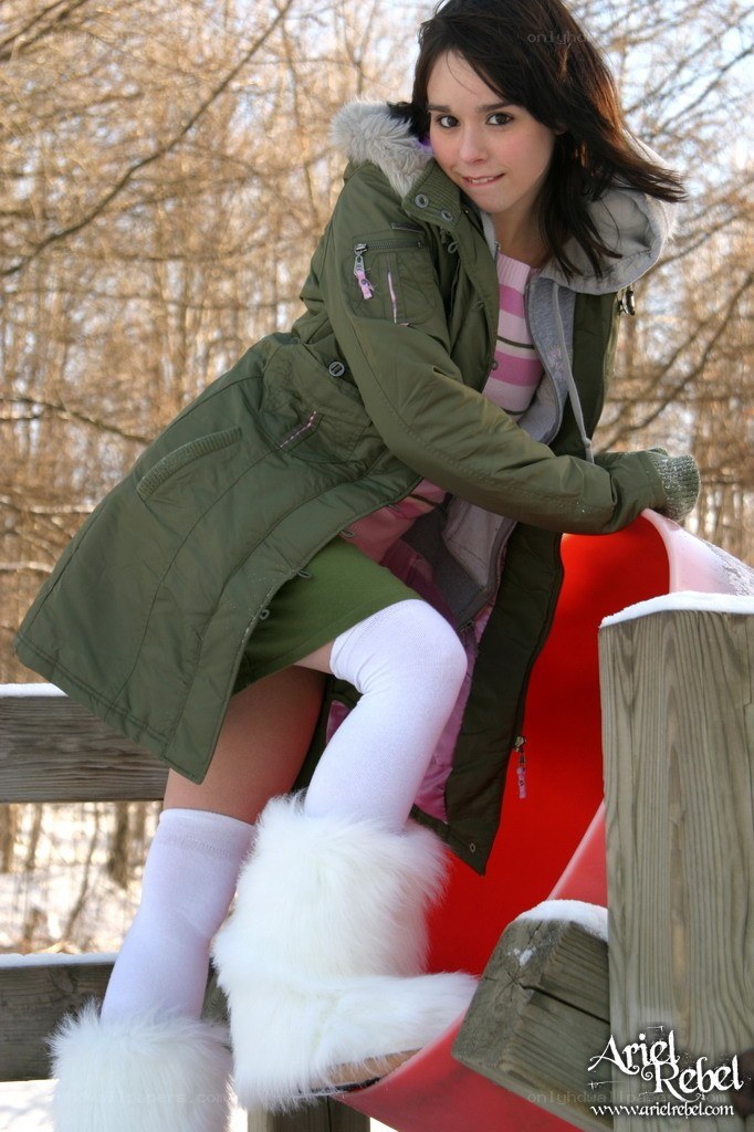 girl in winter coat on slide