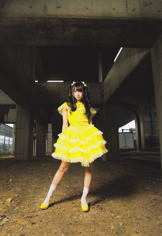 Girl in yellow dress under bridge