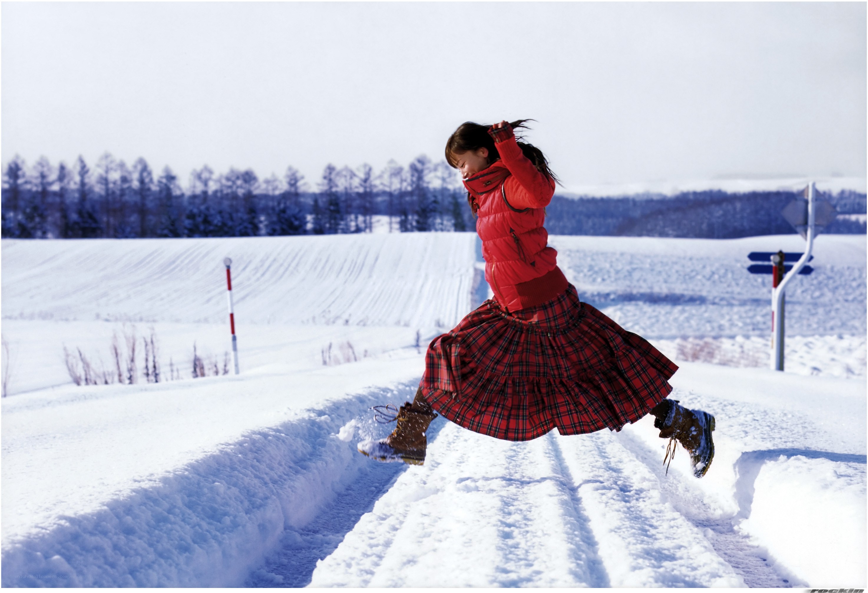 Girl jumping in snowy field