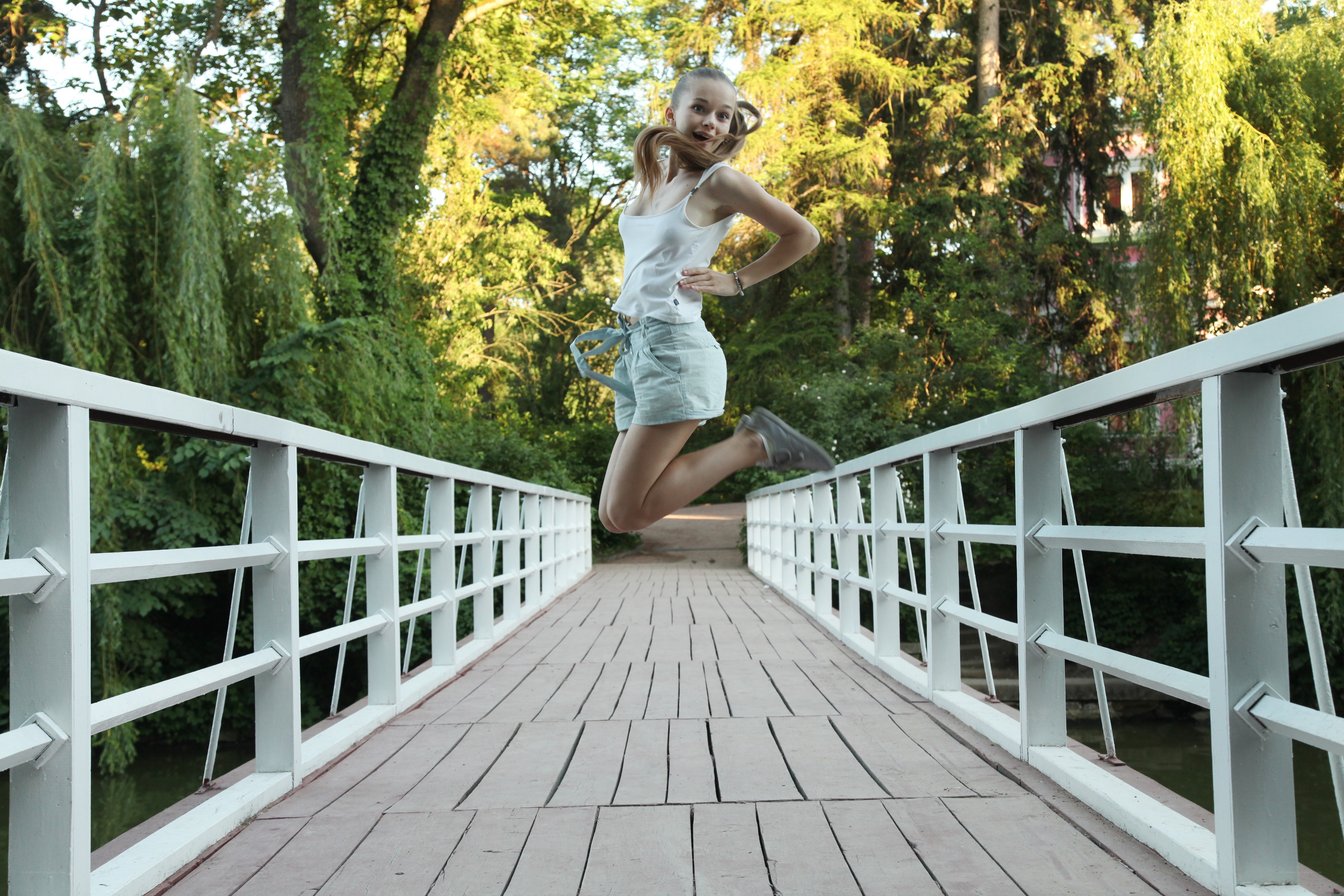 Girl jumping on a bridge