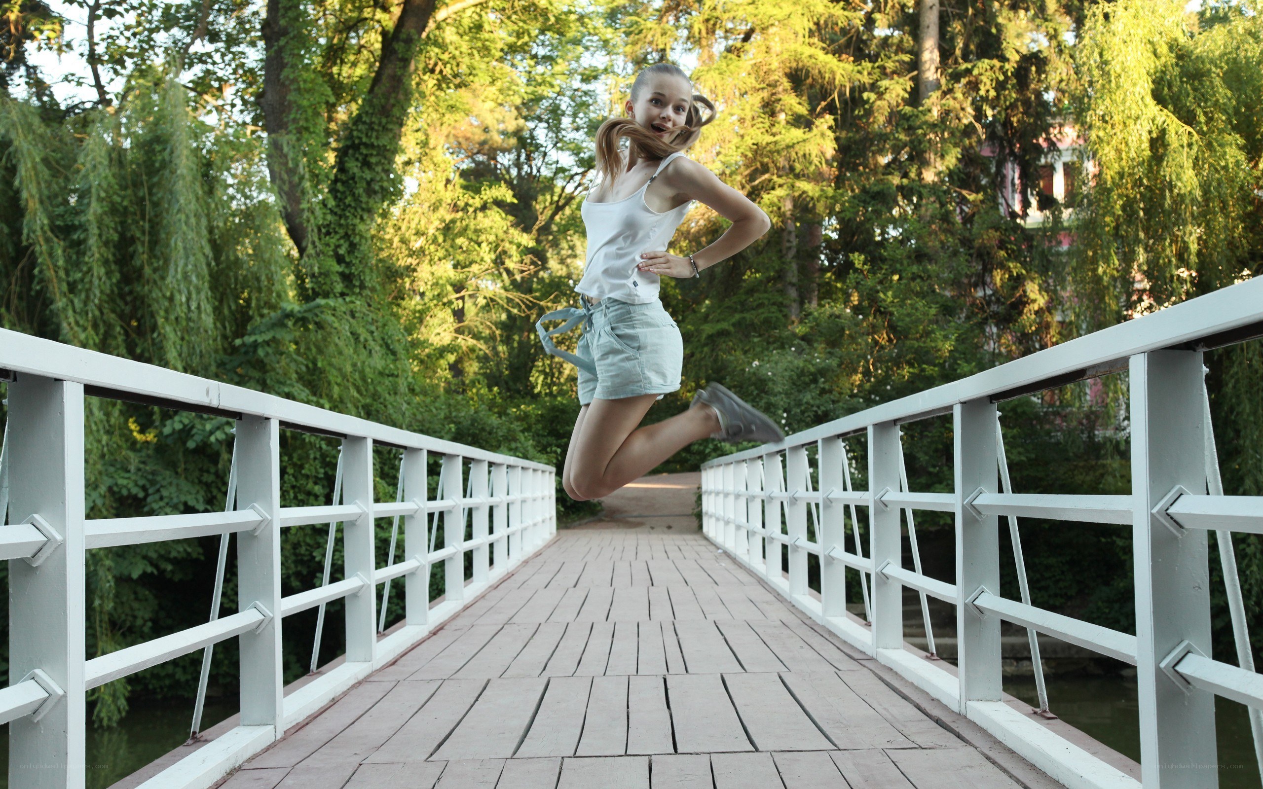 Girl jumping on a bridge