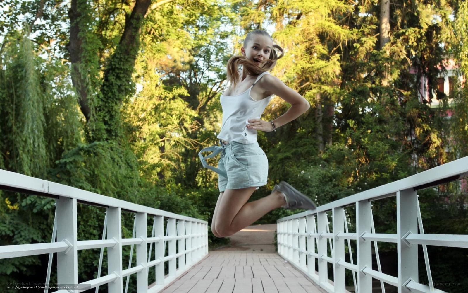 Girl jumping on a bridge