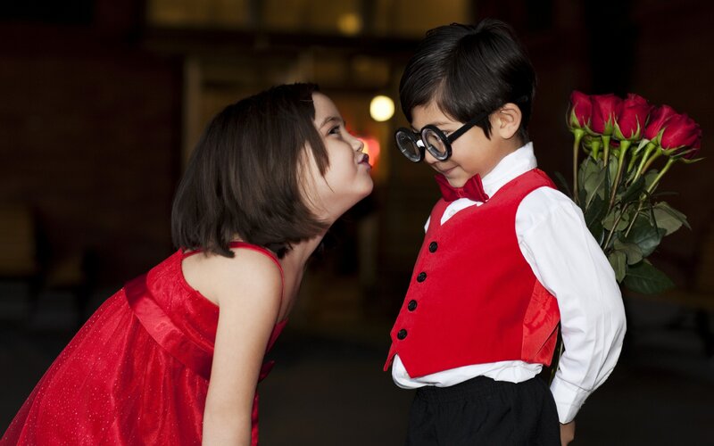 Girl Kissing Boy on Cheek — Red