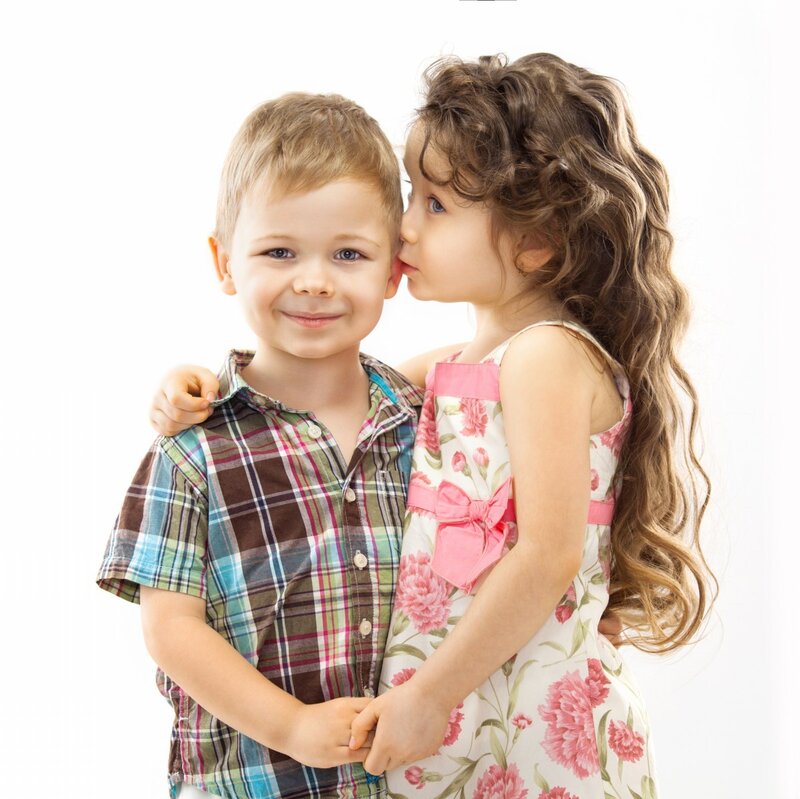 Girl Kissing Boy on Cheek — White