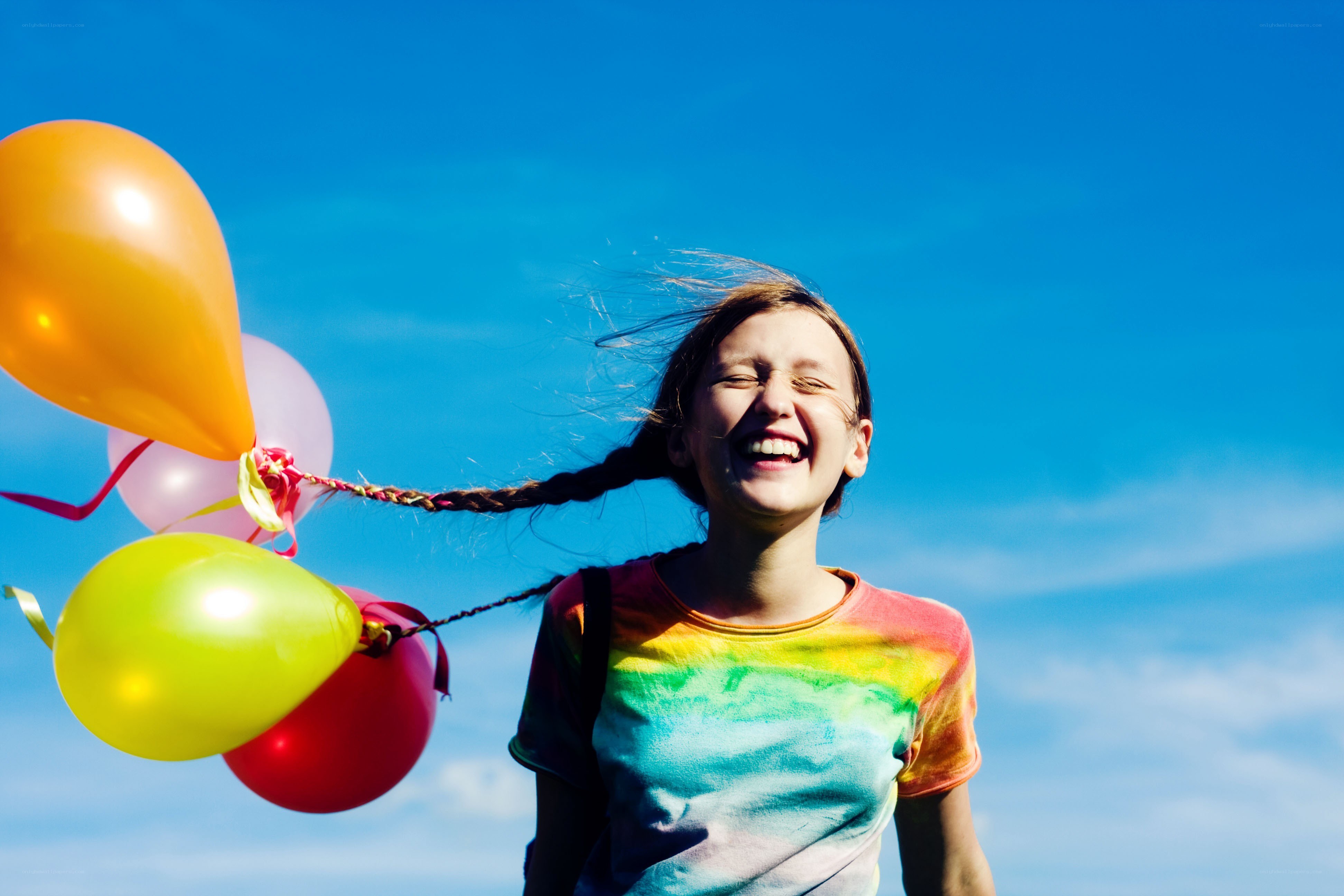 Girl laughing with balloons