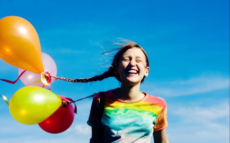Girl laughing with balloons