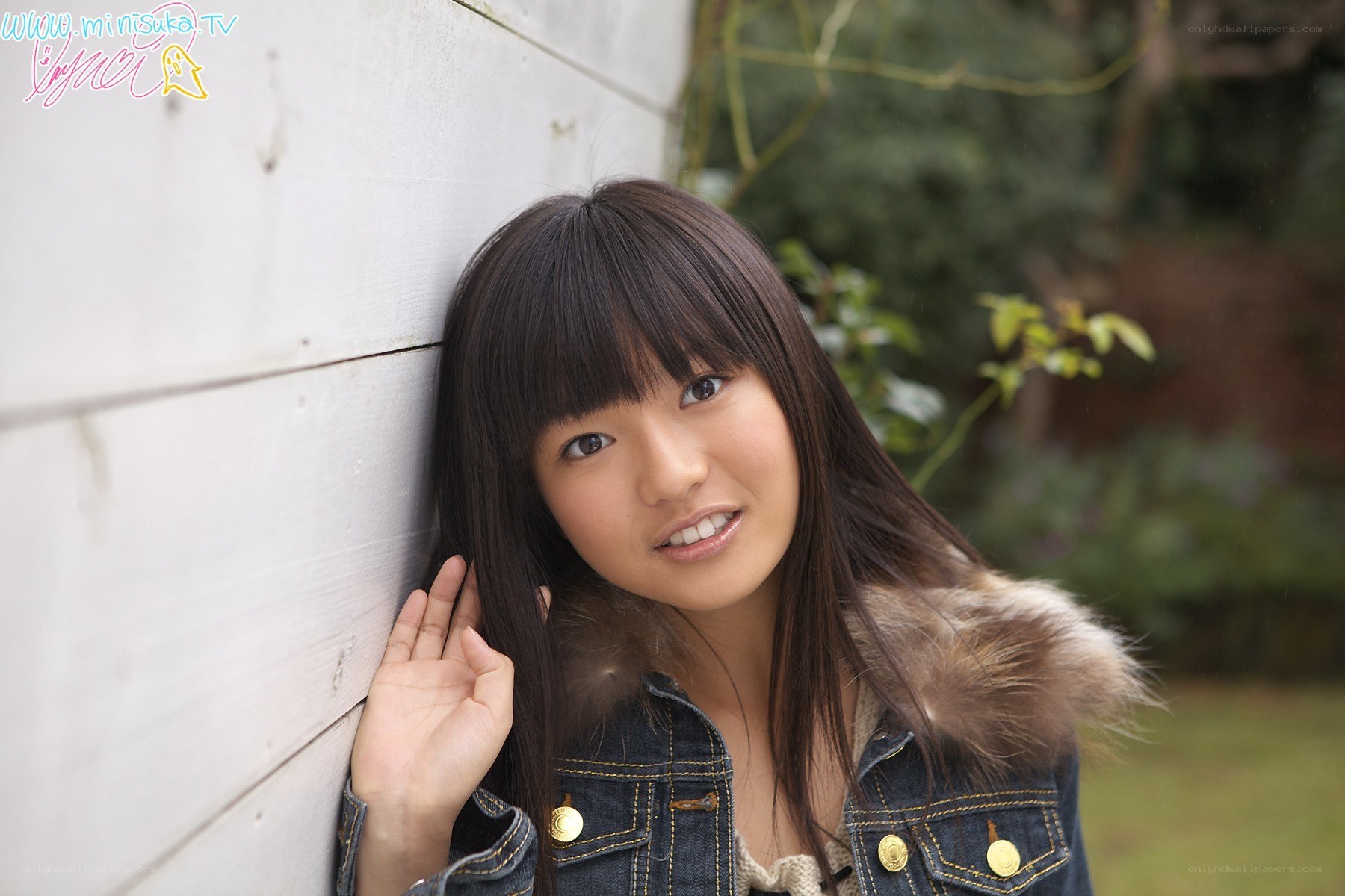 girl leaning against a wall