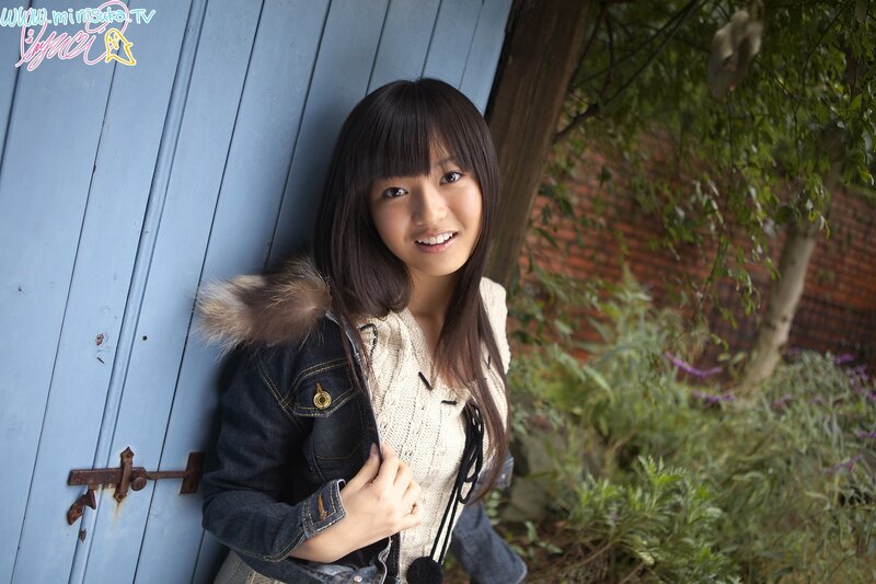 girl leaning against blue door