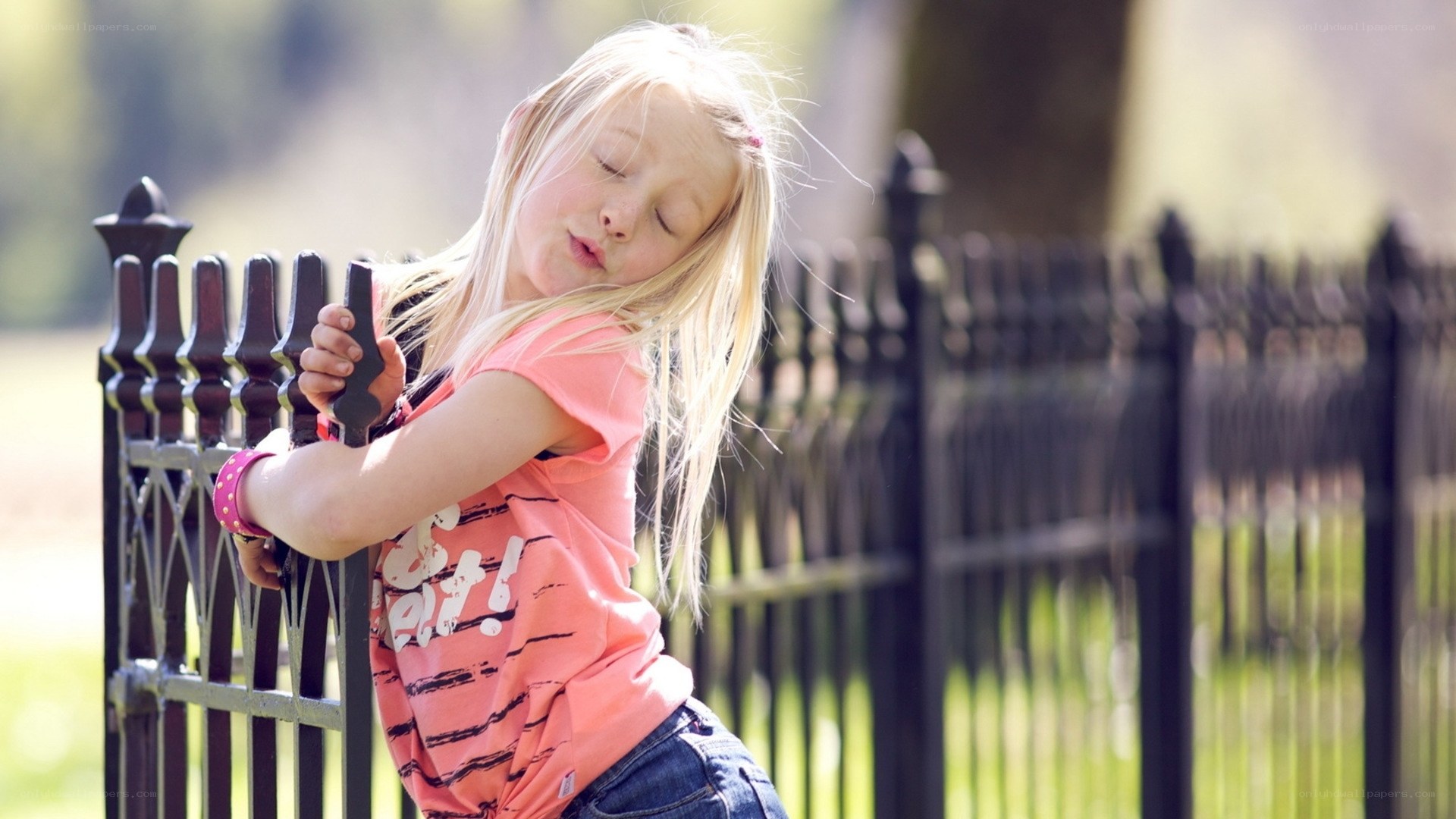 girl leaning on fence