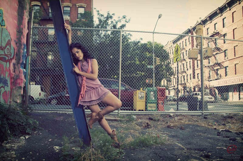 Girl Leaning on Metal Beam