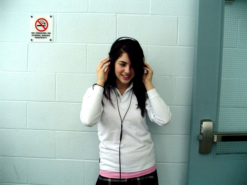 Girl listening to music in hallway