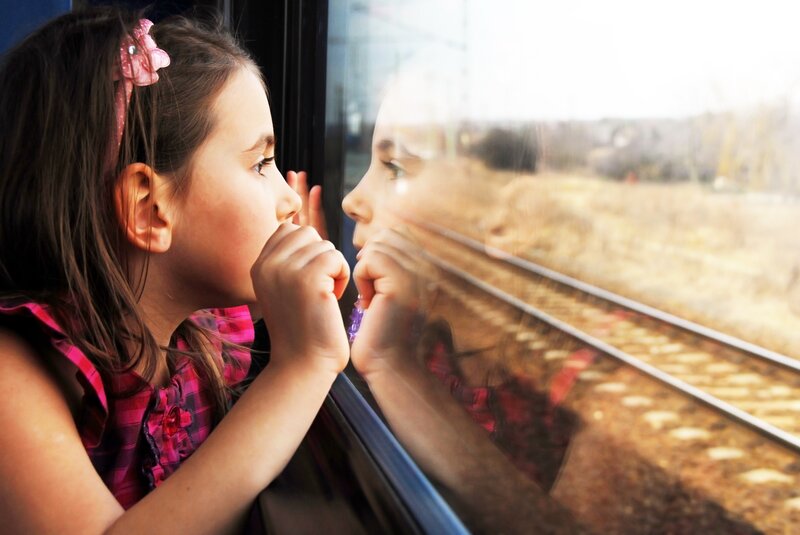 girl looking out train window